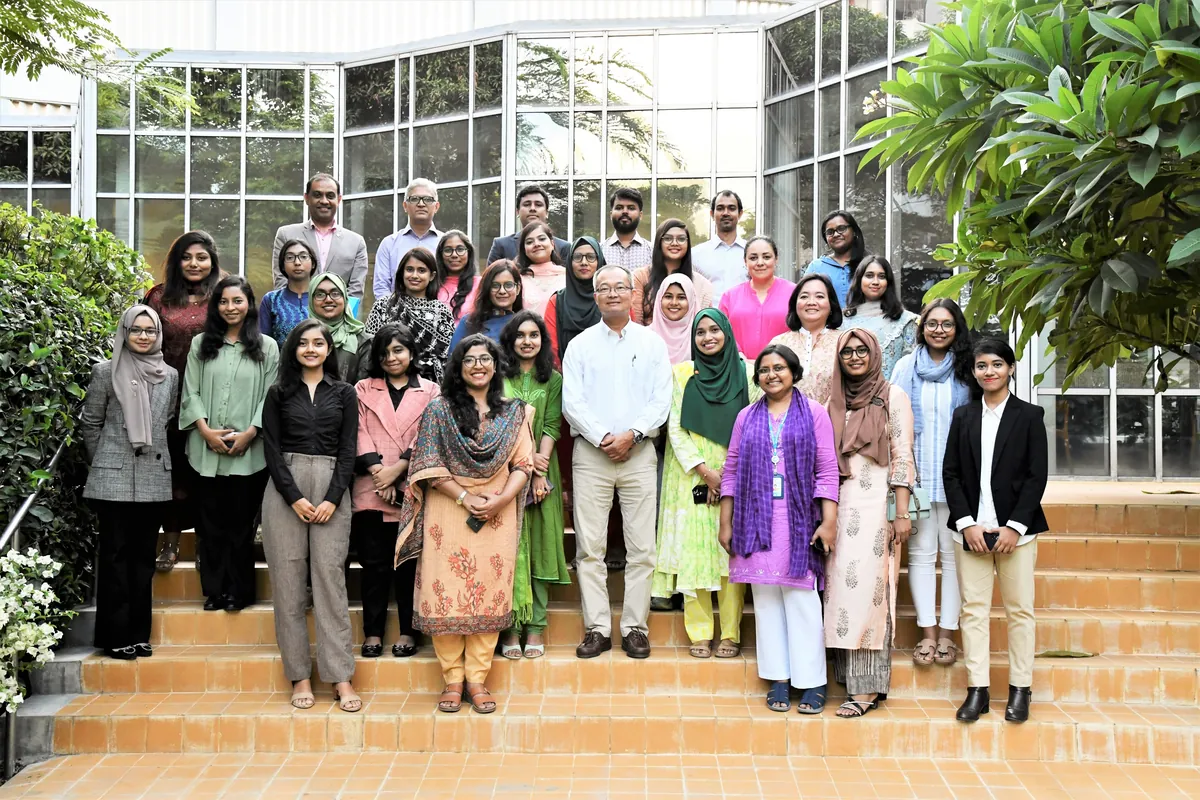 Shoktikonna participants with World Bank mentors on the steps outside an office building